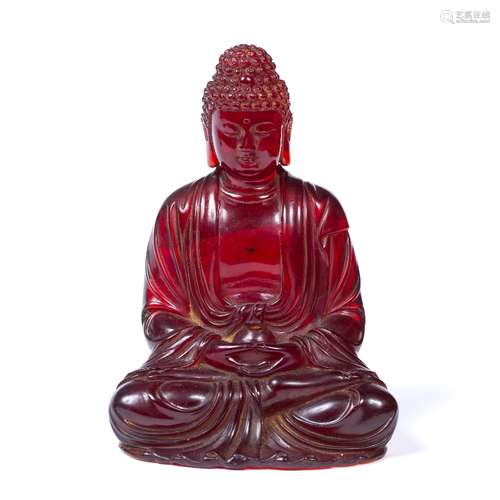 Carved red ambroid figure of Gautama Buddha Chinese, 19th Century seated hands clasped and holding