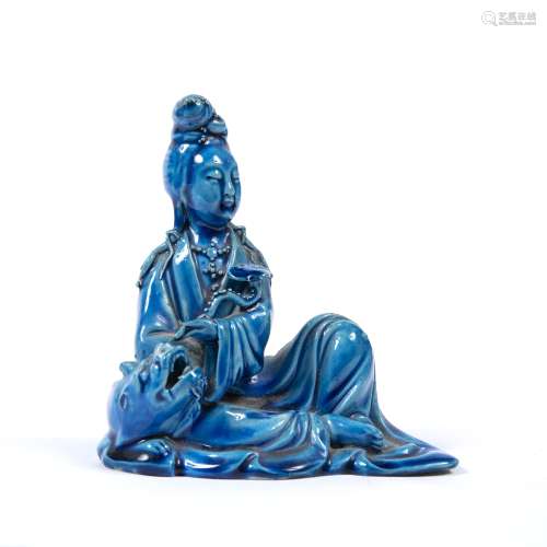 Blue glazed figure of Guanyin Chinese in a recumbent position, with a ruyi sceptre under one arm,