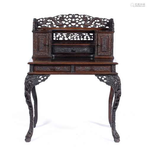 Hardwood carved desk Chinese, late 19th Century with raised back carved with dragons, a drawer to