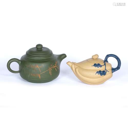 Two Yixing teapots Chinese, 20th Century the first of olive green colour decorated to the sides