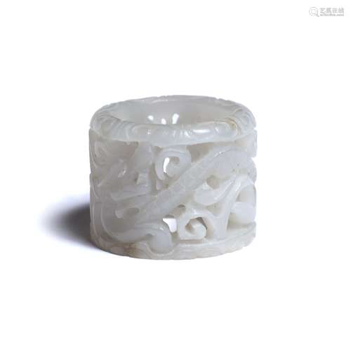 White jade archer's ring Chinese, 19th Century pierced and carved with a dragon and foliage 3.25cm