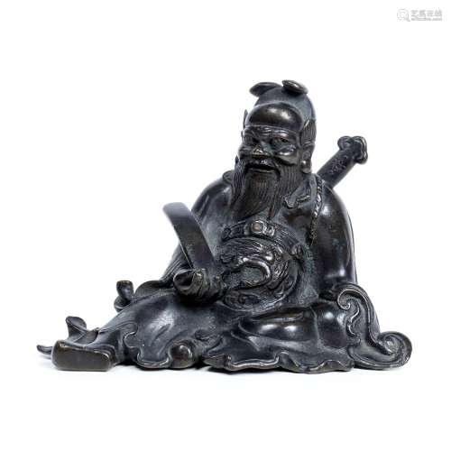 Bronze figure of a seated dignitary Chinese, late Ming holding a sceptre and carrying a sword