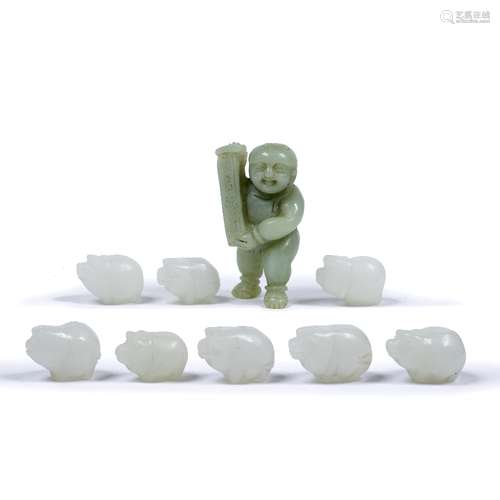 Nine jade pendants Chinese each carved in the form of a pig 3.5cm across and a carved jade boy