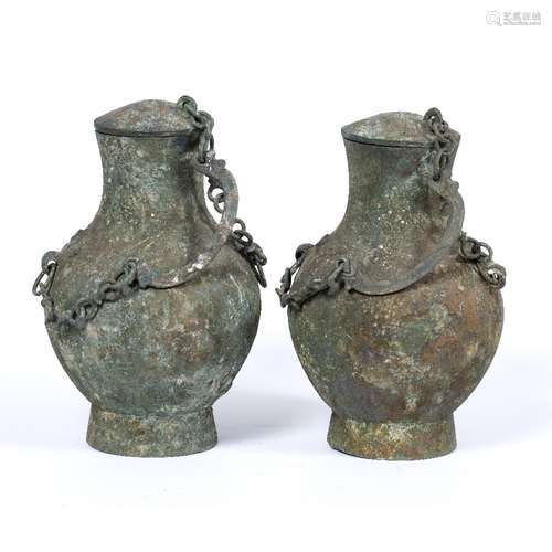 Near pair of bronze Hu vessels Chinese, Warring States period (475-221BC) each with cover held by