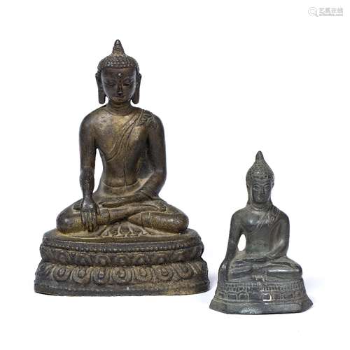 Bronze model of a deity TIbetan depicted sitting cross legged with one hand resting on the laptop,