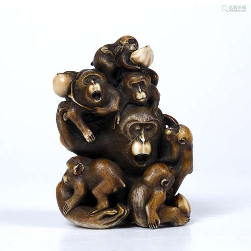 Carved and stained ivory okimono Japanese depicting a monkey seated open mouthed and surrounded by