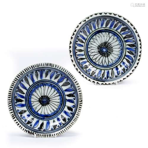 Pair of small pottery dishes Persian, 19th Century each with a simple blue and black central
