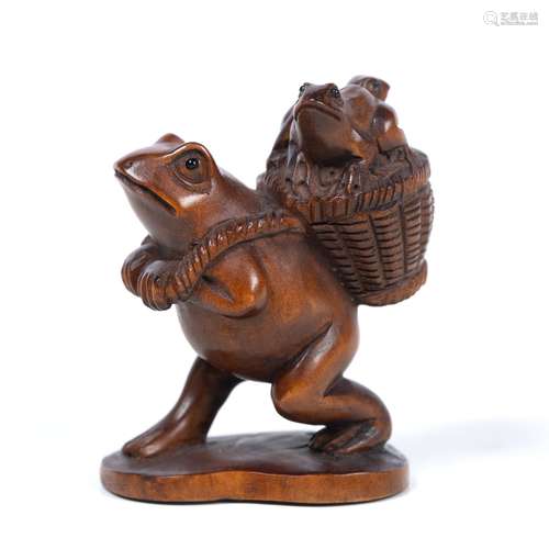 Wood netsuke of a frog walking as a human Japanese, mid Meiji carrying two infants upon a basket