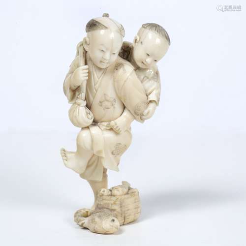 Ivory okimono carved as a boy Japanese, late Meiji carrying a younger sibling as he stands on one