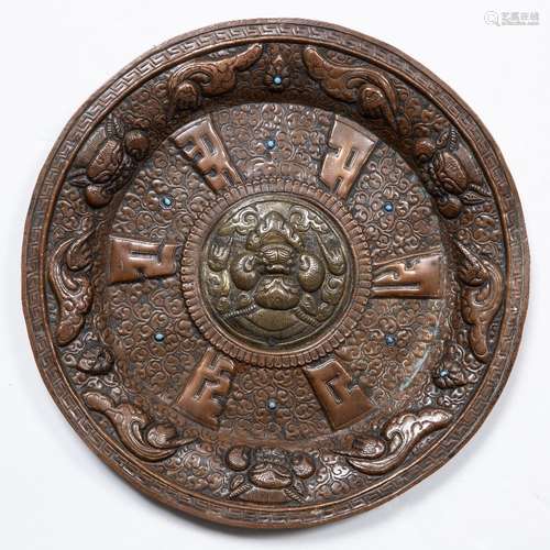 Copper and brass charger Tibetan embossed with Buddhist symbols and inset with turquoise 34.5cm