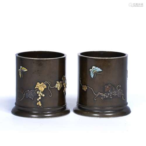 Pair of bronze cylindrical vases Japanese, mid Meiji period on rimmed bases, the bodies decorated in