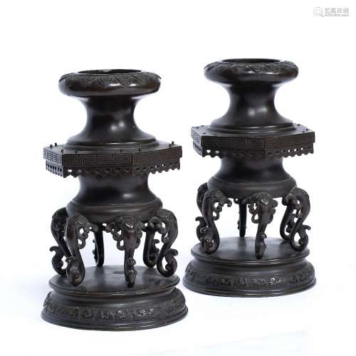 Pair of bronze stands Japanese, 19th Century with elephant stylised scroll supports 29cm high