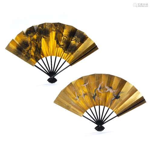 Two lacquer fans Japanese, 20th Century decorated to the centre in gold, the first depicting