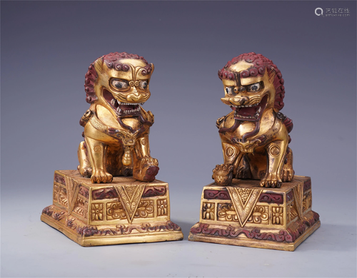 PAIR OF CHINESE GILT BRONZE LION PAPER…