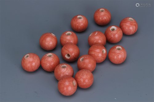 SIXTEEN CHINESE RED GLASS BEADS