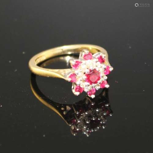 A modern 18ct gold, ruby and diamond set flower head cluster ring, size I, gross weight 3.7 grams.