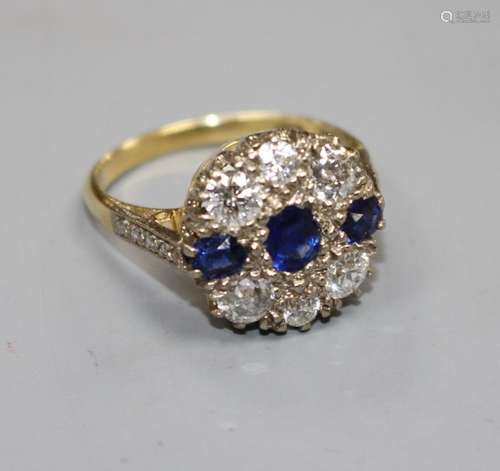 A Victorian style 18ct, three stone sapphire and six stone diamond set circular cluster ring, with