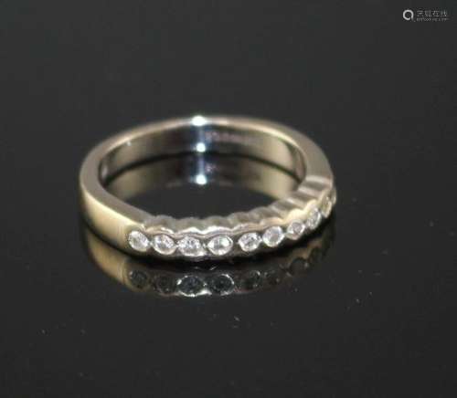 A modern 18ct white gold and ten stone diamond chip set half eternity ring, size M, gross weight 4.5