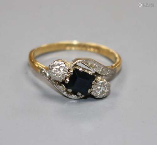 A modern 18ct gold, sapphire and illusion set diamond three stone crossover ring, size L, gross