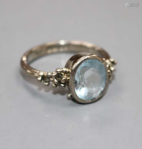 A modern 18ct white gold, aquamarine and marcasite set dress ring, size N, gross weight 5.8 grams.