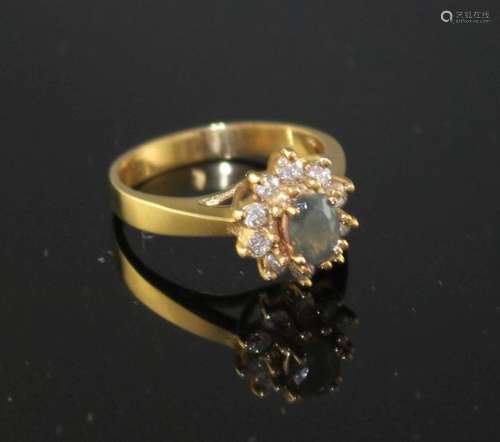 A modern 18k yellow metal, chrysoberyl? and diamond set oval cluster ring, size M, gross weight 4.