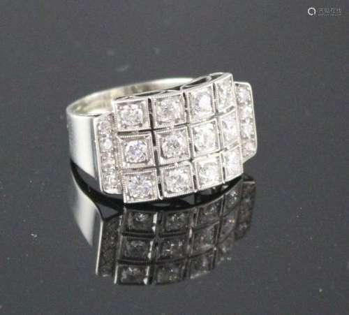 A white metal (stamped 750 and Pt 950) and pave diamond set cocktail ring, of curved design and