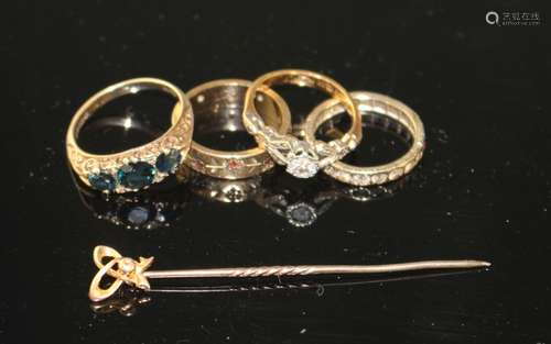 A 1960's 9ct gold and three stone sapphire ring with diamond chip spacers, three other dress rings