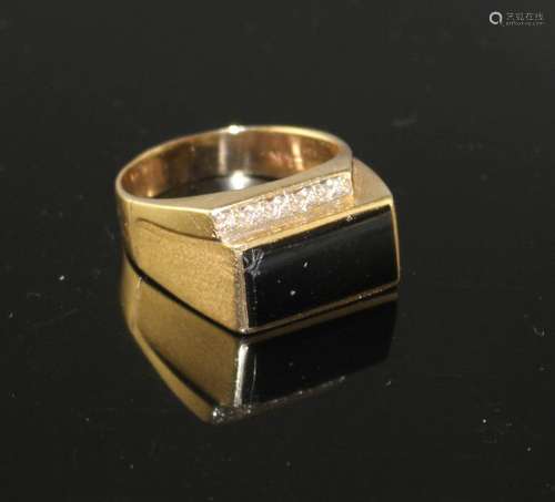 A 14k yellow metal, diamond and black onyx set dress ring, size U/V, gross weight 8.4 grams.