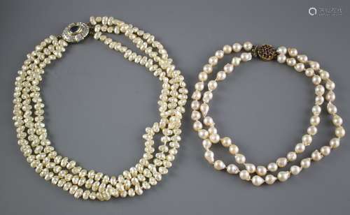 A double strand cultured baroque pearl necklace with yellow metal and garnet ? cluster clasp and one