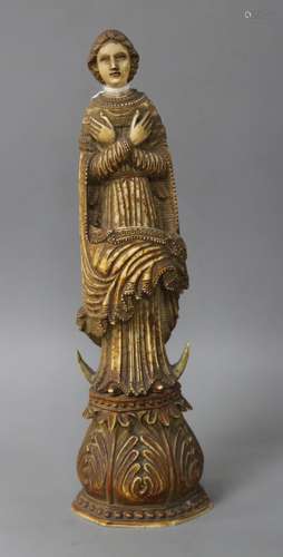 A 17th / 18th century Indo Portuguese carved and stained ivory figure of a saint, height 26cm