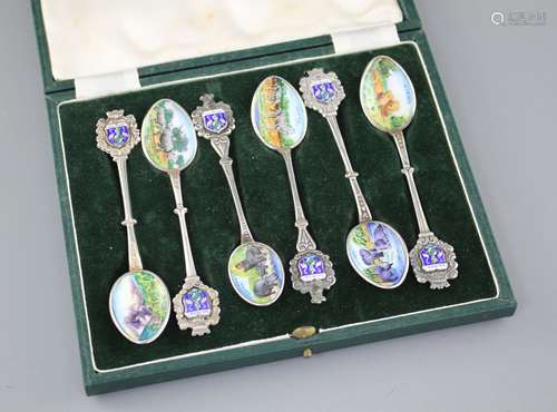 Six white metal and enamel teaspoons, decorated with Nairobi safari scenes with animals, unmarked,