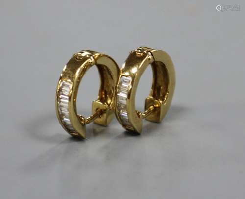 A pair of modern 750 yellow metal and seven stone baguette cut diamond set half hoop earrings,