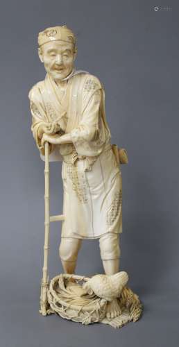 A Japanese ivory Tokyo School ivory okimono, carved as a farmer above a chicken, Meiji period,