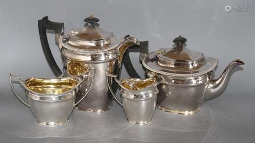 A silver plated four piece tea set, with an associated pair of plated sugar tongs Condition: Needs a