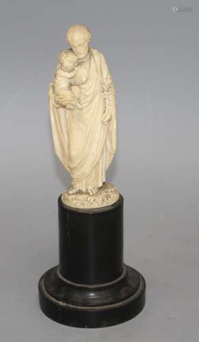 A 19th century Dieppe carved ivory figure of St Joseph holding the Christ child, 16cm