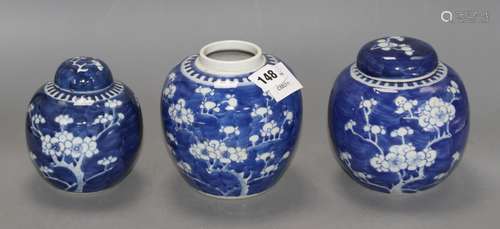 Three Chinese blue and white 'prunus' jars and two covers, early 20th century, height 12cm - 13.