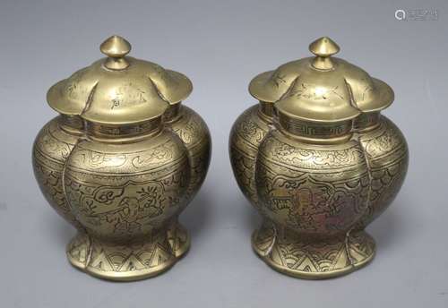 A pair of Chinese brass vases and covers, decorated with figures, cast seal marks to the bases,