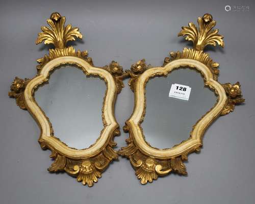 A pair of Italian giltwood cartouche shaped wall mirrors, width 25cm, height 43cm Condition: Some