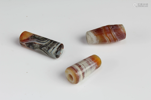 A Group of Three Tibetan 'First-Line' Dzi Beads