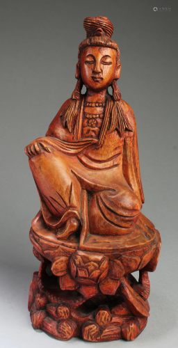 A Carved Wood Deity Statue