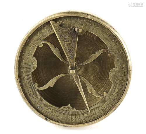 A BRASS QIBLA INDICATOR, SIGNED 'ABD AL-A'IMMA, SAFAVID, ISFAHAN, 17TH CENTURY