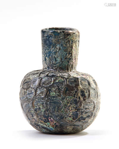 A MOULDED BLUE GLASS BOTTLE, NISHAPUR, NORTH-EAST IRAN, 9TH CENTURY