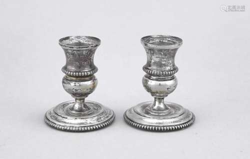 Pair of candlesticks, 20th century, silver tested, round base, vase-shaped capital,perl-relief