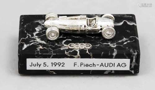 Model of a classic racing car, end of the 20th century, plated, on a rectangular marbleplinth,