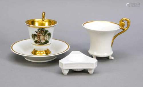 Four pieces KPM Berlin, cup with rosette handle on three paw feet, white, gold rim, markbefore 1945,