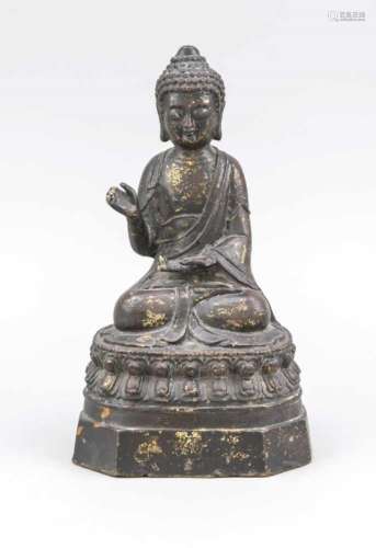 Buddha, China, 19th/20th cent., iron with remnants of gilding. Sitting in Padmasana on adouble lotus