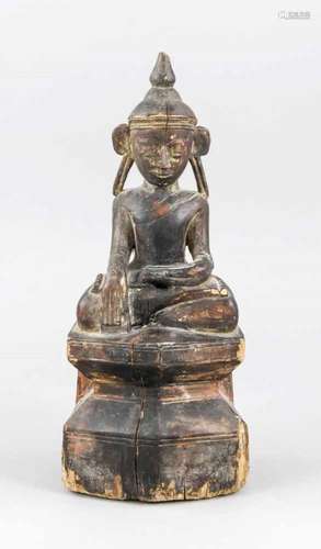 Buddha, probably Tibet, 19th cent. or earlier?, wood with dark patina and remains ofgilding. Sitting