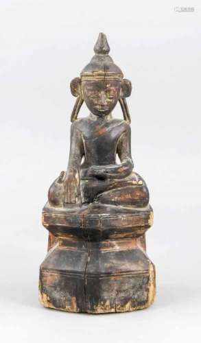 Buddha, probably Tibet, 19th cent. or earlier?, wood with dark patina and remains ofgilding. Sitting