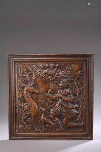 PANEL in walnut carved in bas relief representing …