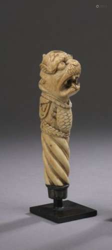Carved ivory dagger handle decorated with a lion's…